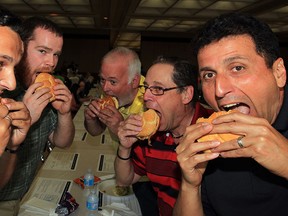 Windsor Mold Group workers Alex Muatovic, left, Gianni Martinello, Joe Gyurcsik, Peter Newman and Lou Savoni, right, were big supporters of annual Poor Boy Luncheon benefitting Cystic Fibrosis Canada Friday June 6, 2014. The event featured pulled pork sandwiches from Tunnel Bar-b-q was held at Giovanni Caboto Club of Windsor. (NICK BRANCACCIO/The Windsor Star)