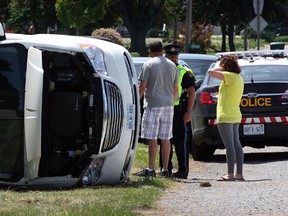 OPP at the scene of a multi-vehicle collision on County Road 14 at County Road 31 (Albuna Townline) Sunday June 15, 2014.  A Chrysler minivan pulling a trailer ended up on its side and a Hyundai Tucson sustained heavy front end damage. One person was taken to hospital by Essex-Windsor EMS paramedics. (NICK BRANCACCIO/The Windsor Star)