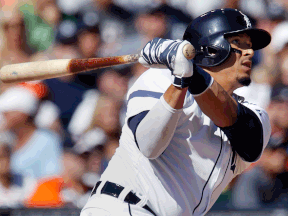 Detroit's Victor Martinez watches his hit that went off the wall above right fielder Oswaldo Arcia of the Minnesota Twins during the third inning at Comerica Park Saturday. (Photo by Duane Burleson/Getty Images)