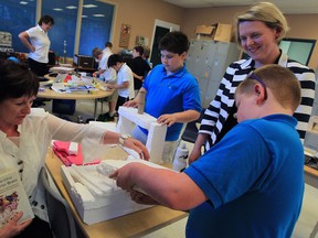 Professor Maureen Harris, left, principal of Lakeview Montessori School, and Allison Hawkins stopped in to see busy students Charles Tamblyn, 10, right,  and Lachlan Maheux, 9, during a class project Monday June 16, 2014. (NICK BRANCACCIO/The Windsor Star)