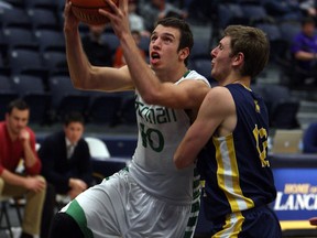 Herman's Marko Kovac, left, takes a shot against Seam Martilano of the Father Michael Goetz Gators at the St. Denis Centre. (TYLER BROWNBRIDGE/The Windsor Star)