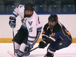 Villanova's James Brooks, left, is checked by St. Anne's Mike Elias at the Vollmer Complex. (DAX MELMER/The Windsor Star)