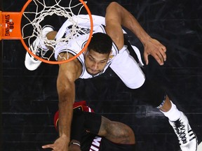 Miami forward LeBron James, bottom, is covered by San Antonio forward Tim Duncan Sunday in Game 5 of the NBA Final. (AP Photo/Andy Lyons, pool)