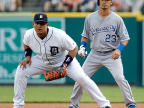 Kansas City's Norichika Aoki, right, positions himself behind first baseman Miguel Cabrera of the Detroit Tigers while leading off during the second inning at Comerica Park. (Photo by Duane Burleson/Getty Images)