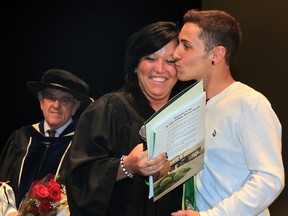 St. Clair College graduate Alysha McNamee received more than her diploma during Convocation Thursday June 19, 2014. McNamee's boyfriend Vincent Poudrier, 23, right, proposed to her seconds after she received congratulations from St. Clair College President Dr. John Strasser. (NICK BRANCACCIO/The Windsor Star)