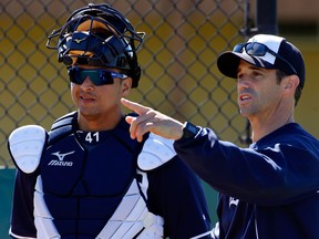 Tigers manager Brad Ausmus, right, talks with Victor Martinez during spring training. (AP Photo/Gene J. Puskar)