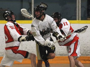 Point Edward's Liam Wright, left, and Blair McFarlane sandwich Windsor's Trevor Leam Wednesday at Forest Glade Arena. (DAN JANISSE/The Windsor Star)