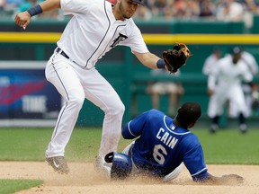 Detroit shortstop Eugenio Suarez, left, prepares to tag out Kansas City's Lorenzo Cain on his steal attempt during the seventh inning at Comerica Park. (AP Photo/Carlos Osorio)