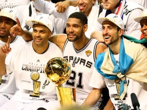 Tony Parker #9 and Tim Duncan #21, and Manu Ginobili #20 of the San Antonio Spurs celebrate after defeating the Miami Heat in Game Five of the 2014 NBA Finals at the AT&T Center on June 15, 2014 in San Antonio, Texas. (Photo by Andy Lyons/Getty Images)