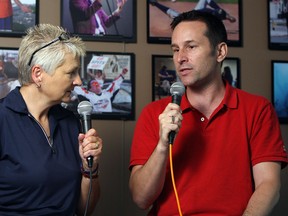 Mary Caton talks with diving coach Aaron Dziver in the News Cafe in Windsor on Thursday, May 29, 2014. (TYLER BROWNBRIDGE/The Windsor Star)