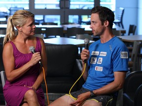 Kelly Steele talks with Sebastien Sasseville, who is almost half way through his solo run across Canada for Diabetes, in the Windsor Star News Cafe in Windsor on Wednesday, June 18, 2014. (Tyler Brownbridge/The Windsor Star)