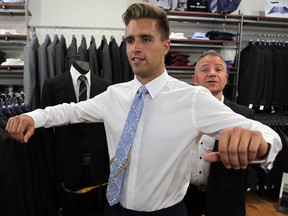 Men's fashion retailer Pete Leardi, right, measures Aaron Ekblad for a suit the he will wear at the NHL draft.  Ekblad may be the first player chosen in the draft.  (NICK BRANCACCIO/The Windsor Star)