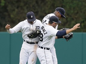 Detroit Tigers outfielders Rajai Davis, from left, Austin Jackson, and J.D. Martinez celebrate their 2-1 win over the Kansas City Royals Thursday in Detroit. (AP Photo/Carlos Osorio)