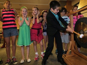 Isaac Czudner, 10,  rings The Mighty Oak Gong which was officially unveiled at Windsor Regional Hospital's Paediatric Program located at Met Campus Monday June 23, 2014. Grade 3 students from St. Gabriel School brought along a generous donation and were treated to a couple of rumbling gongs, a symbol of strength and good luck. The gong will be struck when patients complete their treatments. (NICK BRANCACCIO/The Windsor Star)