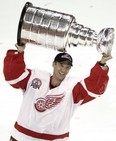 Detroit Red Wings goalie Dominik Hasek carries the Stanley Cup in 2002. (AP Photo/Paul Sancya, file)