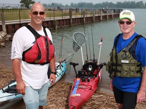 Richard Ofner, left, and Daniel Abraham take a break with their kayaks at Kayaks Cove in 2011. (DAX MELMER/The Windsor Star)