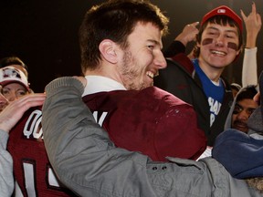 McMaster Marauders quarterback Kyle Quinlan celebrates with fans after winning the CIS Mitchell Bowl against the University of Calgary Dinos in Hamilton. (THE CANADIAN PRESS/Dave Chidley)