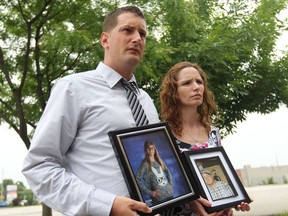 Jason Smulders and Denise Lafontaine hold photos of Alyssa Smulders, 13, and Marc Lafontaine, 35, who both died on the 401 May 10, 2014.   Jason and Denise held a press conference to make a push for concrete barriers on highway 401to prevent future accidents.  (JASON KRYK/The Windsor Star)