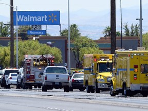 Police and fire vehicles line the street outside a Wal-Mart on June 8, 2014 in Las Vegas, Nevada. Two officers were reported shot and killed by two assailants at a pizza restaurant near the Wal-mart. The two suspects then reportedly went into the Wal-Mart where they killed a third person before killing themselves.  (Ethan Miller/Getty Images)