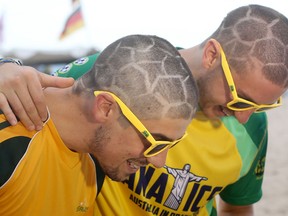 Two Australian fans show off their football-style haircuts at Copacabana beach on June 11, 2014 in Rio de Janeiro, Brazil.  (Clive Rose/Getty Images)