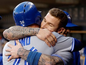 Toronto's Adam Lind, left, gets a hug from Brett Lawrie after hitting a double in the sixth inning to drive in two runs against the Detroit Tigers at Comerica Park. (Photo by Duane Burleson/Getty Images)