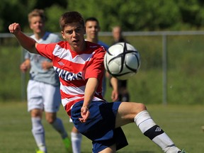 Ryan Resendes of Holy Names kicks the ball against Ancaster Bishop Tonnos in boys AAAA OFSAA soccer at McHugh Park Thursday. (NICK BRANCACCIO/The Windsor Star)