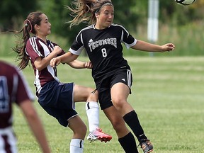 Tecumseh Vista Academy's Alexandria Caputo, right, battles for the ball with King's Christian Collegiate's Melissa Mitzsal at the Vollmer Centre Friday. (TYLER BROWNBRIDGE/The Windsor Star)