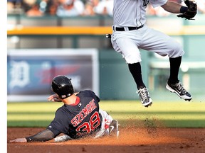 Detroit second baseman Ian Kinsler, right, jumps after throwing to first base as Boston's Grady Sizemore slides into second base on a Jonathan Herrera fielders choice in the second inning at Comerica Park. (AP Photo/Paul Sancya)
