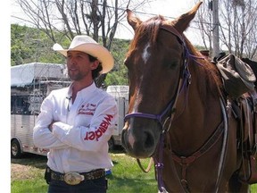 Filipe Masetti Leite speaks to a reporter before riding out of the Stampede grounds in Calgary on Sunday, July 8, 2012. A Canadian cowboy can truly call himself a long rider as he has reached his destination country in an epic horseback journey to Brazil from Calgary. (Bill Graveland/The Canadian Press)