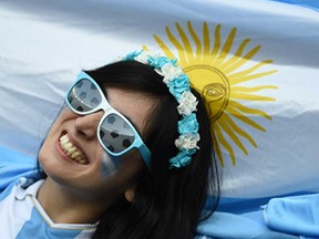 Argentina fans celebrate a goal during the World Cup Group F match between Argentina and Iran at Estadio Mineirao on June 21, 2014 in Belo Horizonte, Brazil. (BEHROUZ MEHRI/AFP/Getty Images)