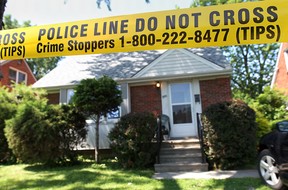 A home in the 900 block of Reedmere Rd. in Windsor, Ont. is surrounded by police tape Thursday, June 26, 2014, as police investigate attempted murder.  (DAN JANISSE/The Windsor Star)