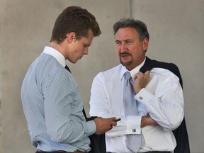 Windsor Spitfire player Ben Johnson, left, is shown with his lawyer Pat Ducharme outside of the Ontario Court in Windsor, Ont. on Tuesday, June 3, 2014. (DAN JANISSE/The Windsor Star)