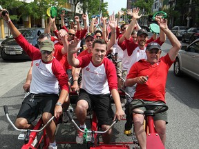 Mike Palaszynski, left, and Chad Harris, lead the way with volunteer driver, Gary Blaire, right, for Windsor Mold Group in the Heart and Stroke Foundation's Big Bike in downtown Windsor, Friday, June 6, 2014.  (DAX MELMER/The Windsor Star)