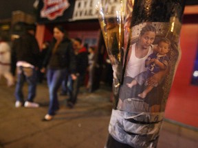 Patrons of the former Box Office Sports Bar make their way past a memorial for Luis Acosta-Escobar after the club closed in the early hours of Dec 29, 2007. (Tyler Brownbridge/The Windsor Star)