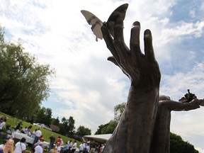The Butterfly Brain Injury Memorial, dedicated by the Brain Injury Association of Windsor/Essex County, is unveiled at Assumption Park, Friday, June 6, 2014.  The memorial is in honour of those affected by brain injuries.  It depicts two hands letting loose two butterflies. (DAX MELMER/The Windsor Star)