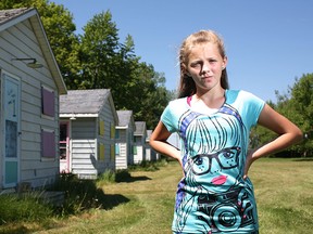 Taylor Mason, 11, is pictured next to a row of cabins at the Kiwanis Sunshine Point Camp in Harrow, Saturday, May 31, 2014.  Mason has attended the camp for the last three years but may not be able to attend this summer.  The camp has encountered funding issues and is in jeopardy of closing.  (DAX MELMER/The Windsor Star)