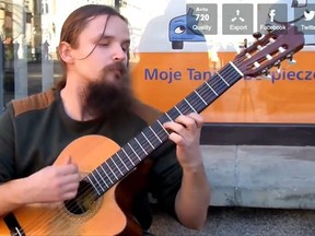 Polish street artist and guitar-playing busker, Mariusz Goli.