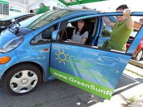 Tanja Nuske shows off her Mitsubishi MiEV to Lisa Booth, left, as the Renewable Energy Technology Center in cooperation with the University of Windsor host the fifth annual Electric Vehicle Event at the Renewable Energy Technology Centre in Windsor on Saturday, June 14, 2014. The latest in electric vehicle technology was featured and guests were invited to bring their own electric vehicle. (Tyler Brownbridge/The Windsor Star)