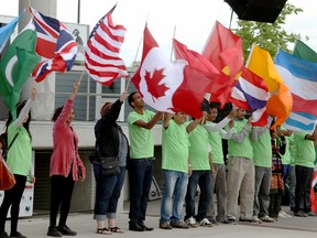 In this file photo, students and volunteers of Carrousel by the River hold flags of countries at the Riverfront Festival Plaza Friday, June 13. (RICK DAWES/The Windsor Star)