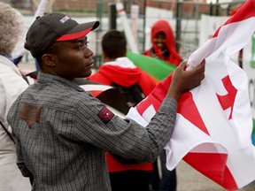 Forester High School student Amani Muharanye holds a Georgian flag after the Carrousel by the River opening ceremonies, at Riverfront Festival Plaza Friday, June 13. This event kicks off Carrousel of the Nations, a celebration of multiculturalism in Windsor. (RICK DAWES/The Windsor Star)