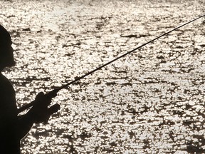A fisherman tries his luck on Monday, June 16, 2014, near the Reaume Park in Windsor, Ont. as the sun begins to set. (DAN JANISSE/The Windsor Star)