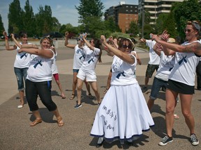 Beverly Brissette, centre, organizer for Gail's Way Colin Cancer Awareness, leads dancers in a dance-a-thon at Coventry Gardens, Sunday, June 1, 2014.  (DAX MELMER/The Windsor Star)