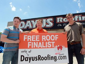 Greg Wiklanski, Frank Dayus, and Frank Dayus display a sign during a promotional event that will result in a home receiving a free roof.  (JASON KRYK/The Windsor Star)