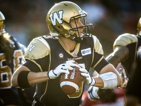 Winnipeg Blue Bombers' quarterback Drew Willy looks to make a pass during CFL pre-season football action against the Calgary Stampeders in Calgary, Alta., Saturday, June 14, 2014. THE CANADIAN PRESS/Jeff McIntosh