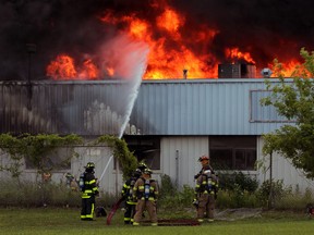Windsor firefighters battle the blaze at the Wickes site on June 25, 2014.