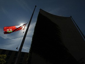 The flags at City Hall Square in downtown Windsor, Ont. are pictured at half mast in this 2011 file photo. (DAX MELMER/The Windsor Star)