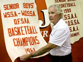 Forster  student Doug Cowan inspects the 1961 OFSAA championship banner he was a part of winning at the silent auction Saturday, June 21, 2014. (JOEL BOYCE/The Windsor Star)