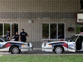 Windsor police officers investigate a scene after a call was received for a man bleeding from the neck, Monday, June 30, 2014, at the corner of Glengarry Avenue and Tuscarora  Street. Two men were taken to hospital following an altercation with a weapon. (RICK DAWES/The Windsor Star)