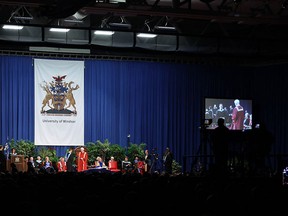 Students cross the floor to receive the degrees during the first round of convocations at the University of Windsor on Wednesday, June 11, 2014. (Tyler Brownbridge/The Windsor Star)