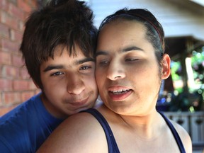 Jacob Mitchell, 13, is shown with his mother Rosa Mitchell on Monday, June 9, 2014, at their Windsor, Ont. home. Jacob suffered skull fractures after being attack by a man with a hammer in the 1000 block of Church St. on Friday. (DAN JANISSE/The Windsor Star)
